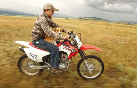 Young boy and his dog on a dirt bike