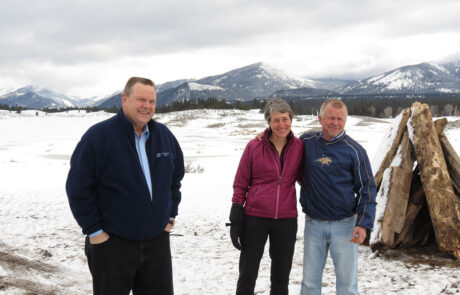 Three people outside in a snowy landscape